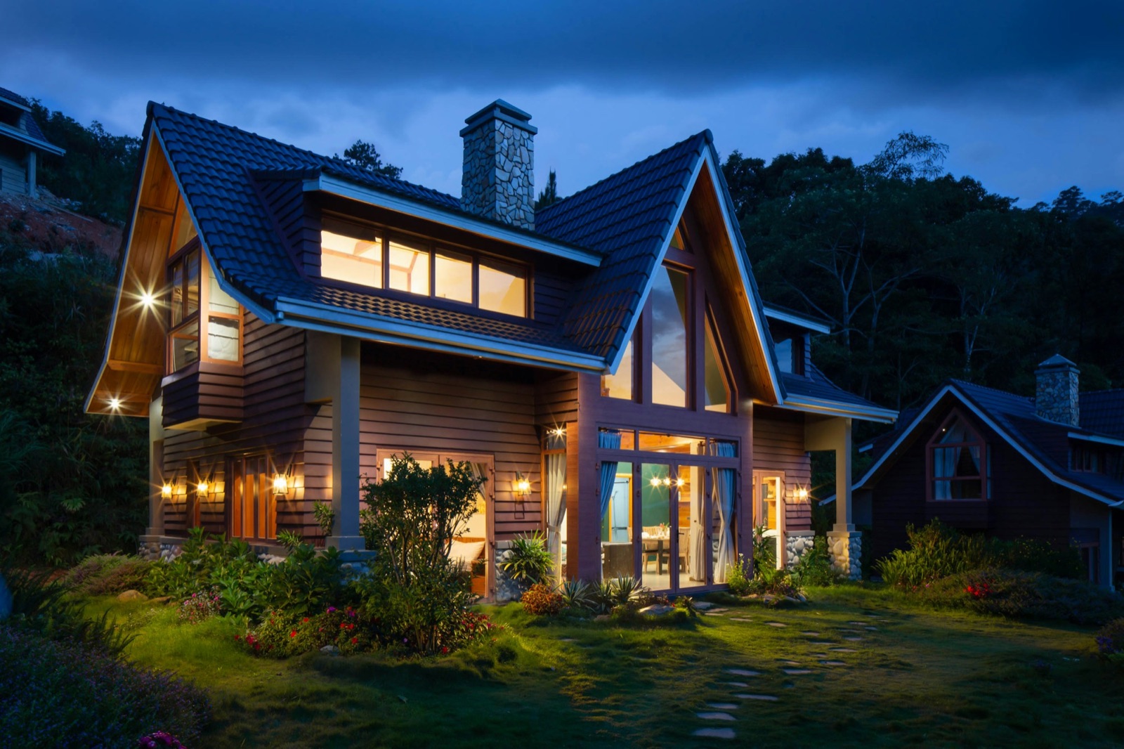 Hudson Valley home at dusk, warm windows glowing